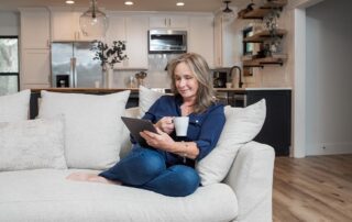 woman on couch upgrades hvac for comfort