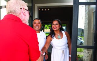 salesman greeting couple on porch