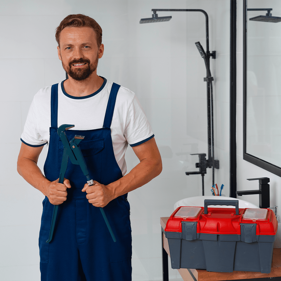 Plumber smiling with tools