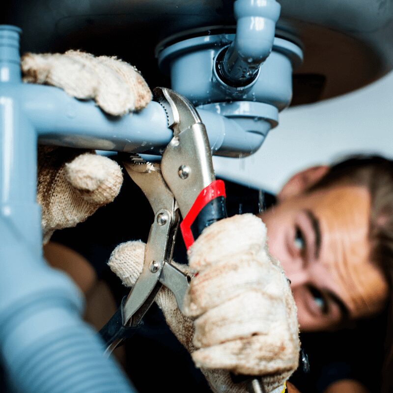 plumber fixing office kitchen sink