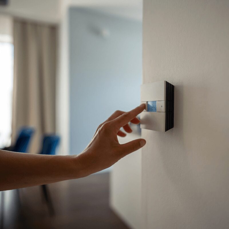 woman’s hand adjusting heating settings